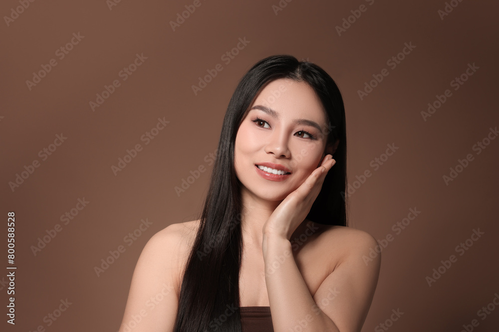 Portrait of beautiful woman on brown background Portrait of beautiful woman on brown background