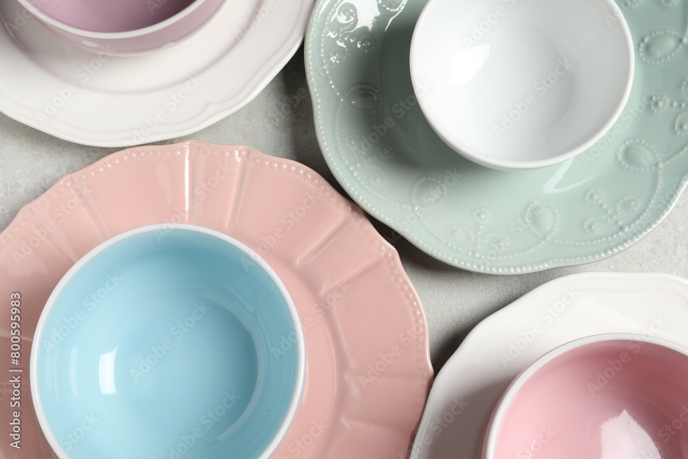 Beautiful ceramic dishware on light grey table, flat lay Beautiful ceramic dishware on light grey table, flat lay