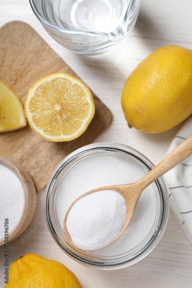 Baking soda, vinegar and lemons on white wooden table, flat lay Baking soda, vinegar and lemons on white wooden table, flat lay