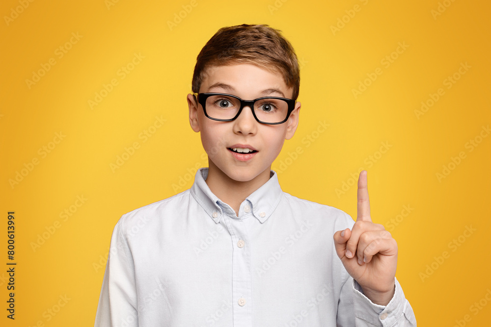 Smart teen boy in glasses having idea Smart teen boy in glasses having idea