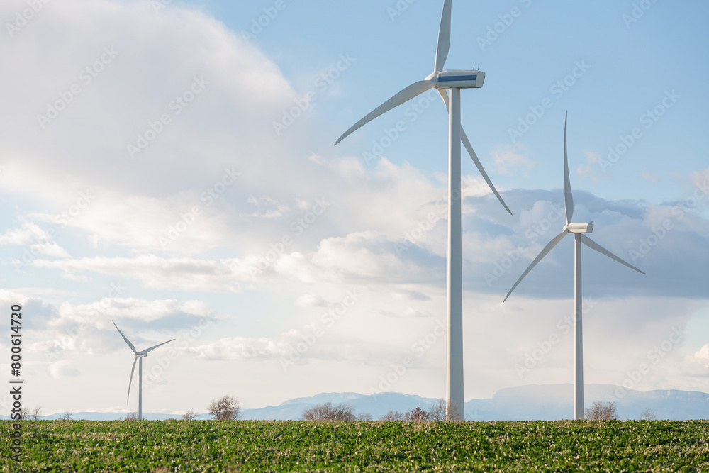 Three wind turbines are standing in a field Three wind turbines are standing in a field