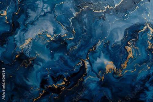 Close up of swirling blue and gold marble pattern resembling a water painting