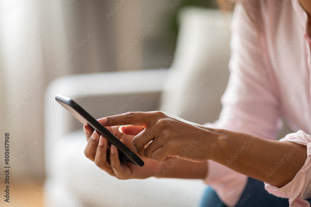 Fototapeta premium Relaxed Woman Engaging with Social Media on Couch