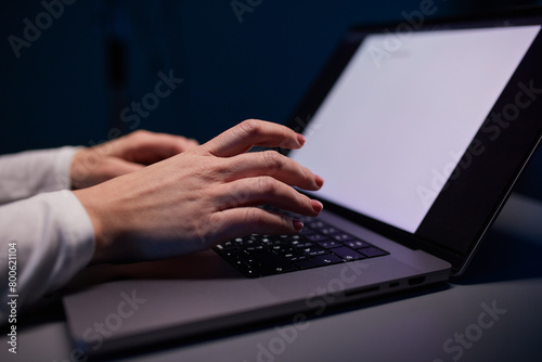 Close-up shot of female hands typing on laptop. Woman fingers tapping on computer keyboard. Work concept
