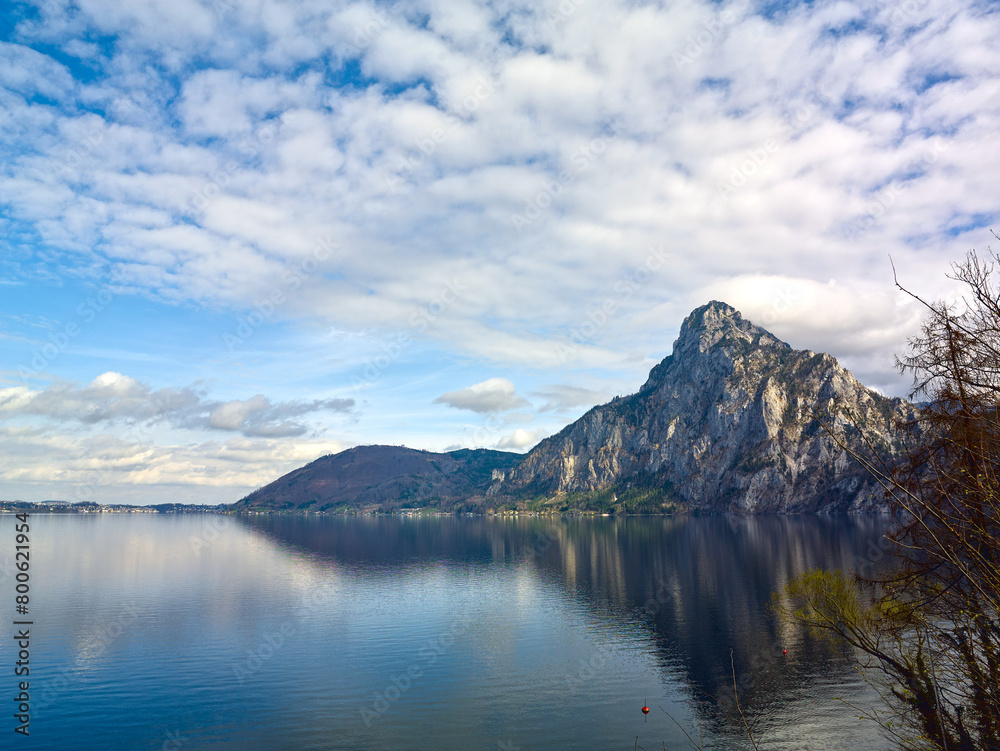 Peaceful spring mountain lake in the Alps. View of Lake Traunsee and Mount Traunstein in background. Upper Austria.