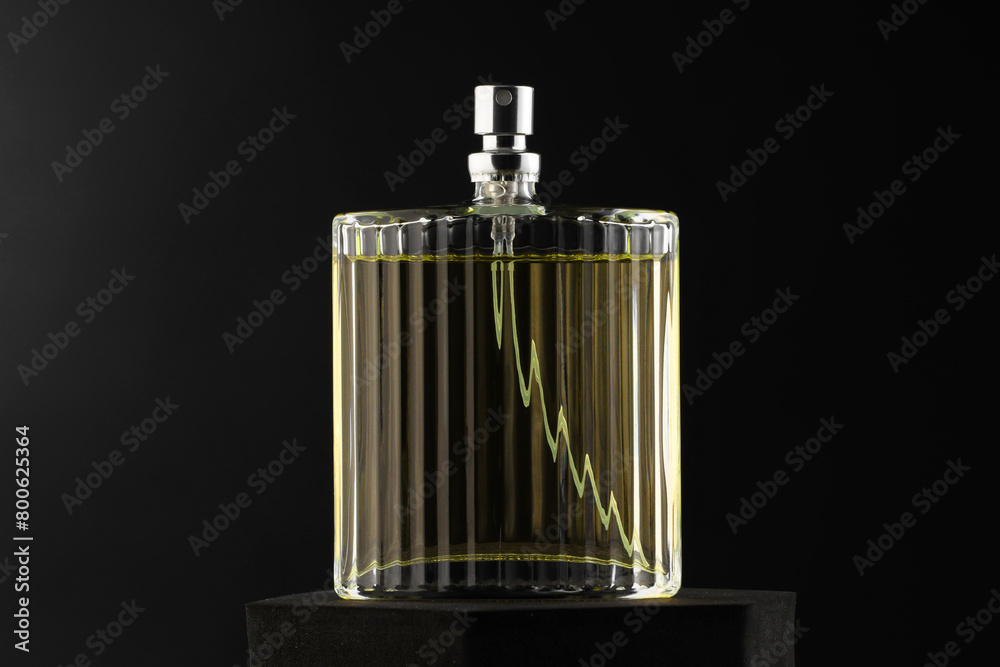 Luxury men`s perfume in bottle against dark background Luxury men`s perfume in bottle against dark background