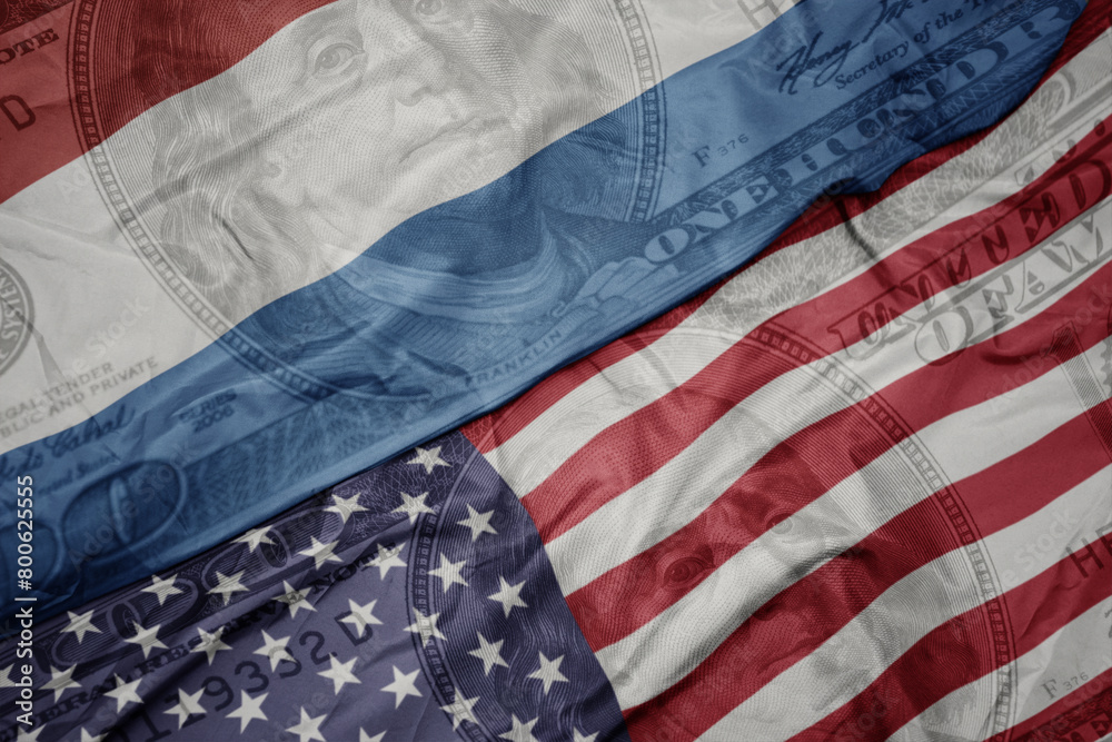 Obraz premium waving colorful flag of united states of america and national flag of luxembourg on the dollar money background. finance concept. macro