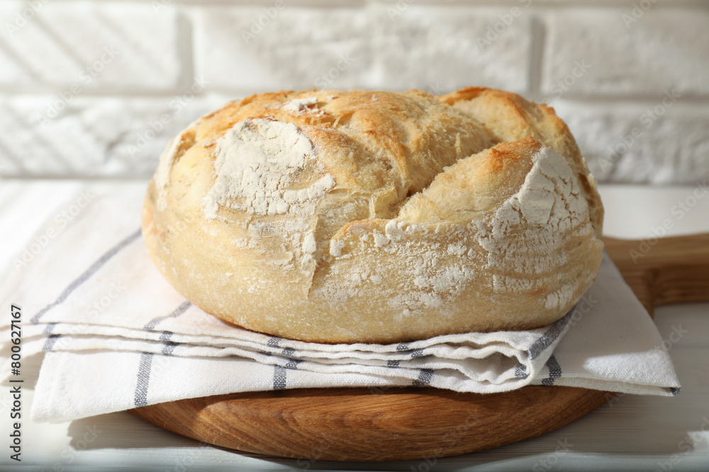 Naklejka premium Freshly baked sourdough bread on white table