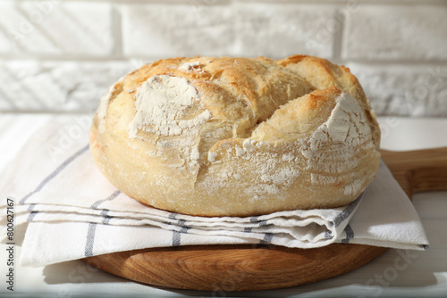 Freshly baked sourdough bread on white table