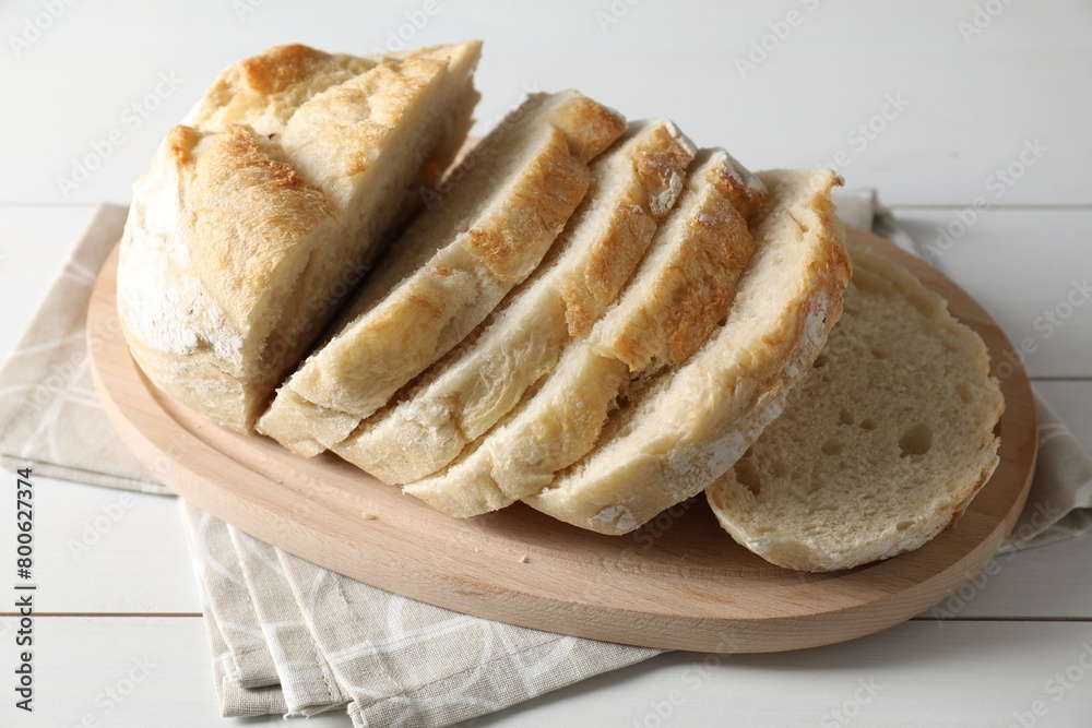 Freshly baked cut sourdough bread on white wooden table Freshly baked cut sourdough bread on white wooden table