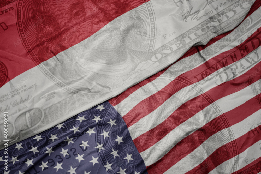 Obraz premium waving colorful flag of united states of america and national flag of indonesia on the dollar money background. finance concept.