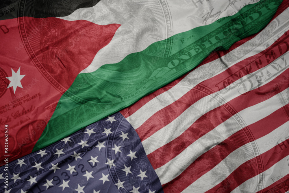 Obraz premium waving colorful flag of united states of america and national flag of jordan on the dollar money background. finance concept.
