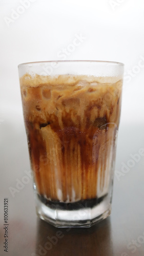 Chilled Ice Coffee Latte in a Clear Tall Glass.