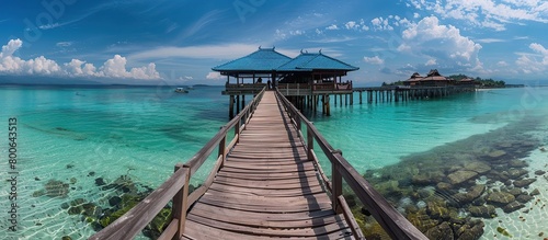 Panoramic landscape of Maldives beach. Tropical panorama, luxury water villa resort with wooden pier or jetty.