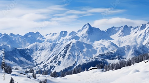 panoramic view of the alps in winter with snow and blue sky