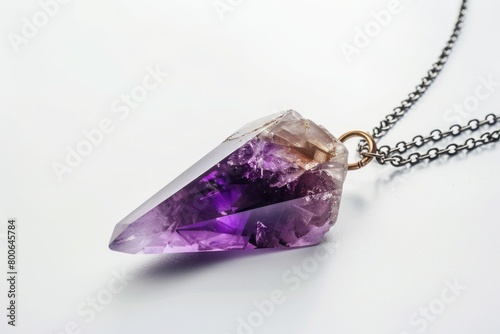 A purple amethorate displayed on a chain. Suitable for jewelry or crystal healing concepts photo