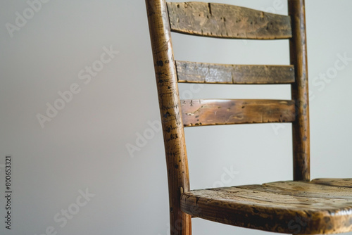 A close-up of a ladderback chair on a solid white background.