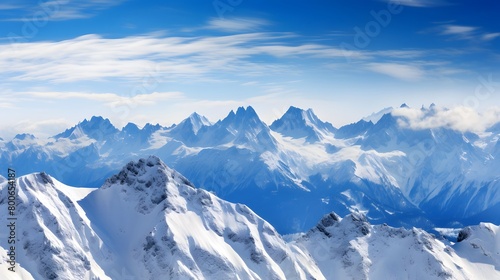 Panoramic view of snowy mountains in the clouds. Winter landscape