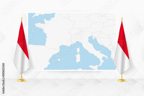 Map of Monaco and flags of Monaco on flag stand.