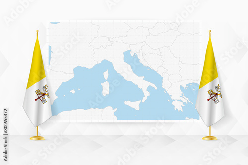 Map of Vatican City and flags of Vatican City on flag stand.