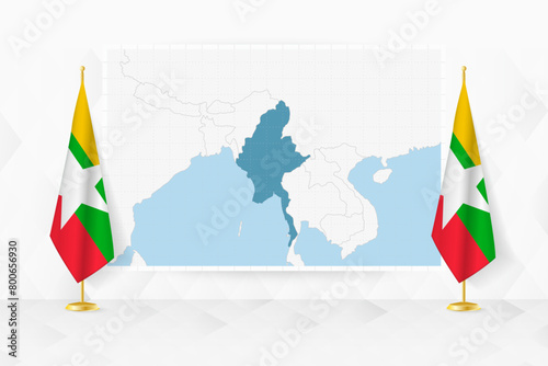 Map of Myanmar and flags of Myanmar on flag stand. photo