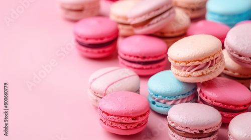 colorful macarons arranged in a light pink background