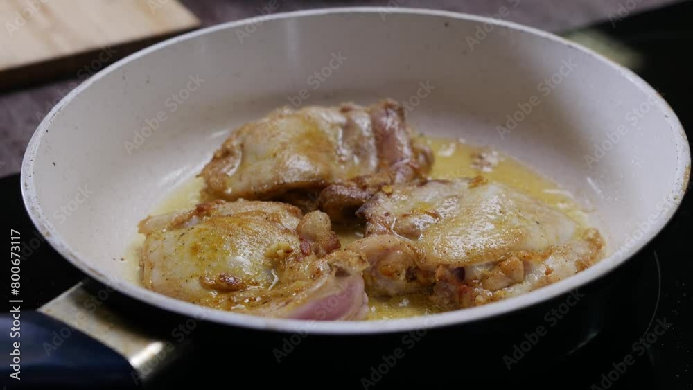Seasoned chicken breast is fried in boiling oil in a hot ceramic pan with a white base. Close up. 4k. Seasoned chicken breast is fried in boiling oil in a hot ceramic pan with a white base. Close up. 4k.