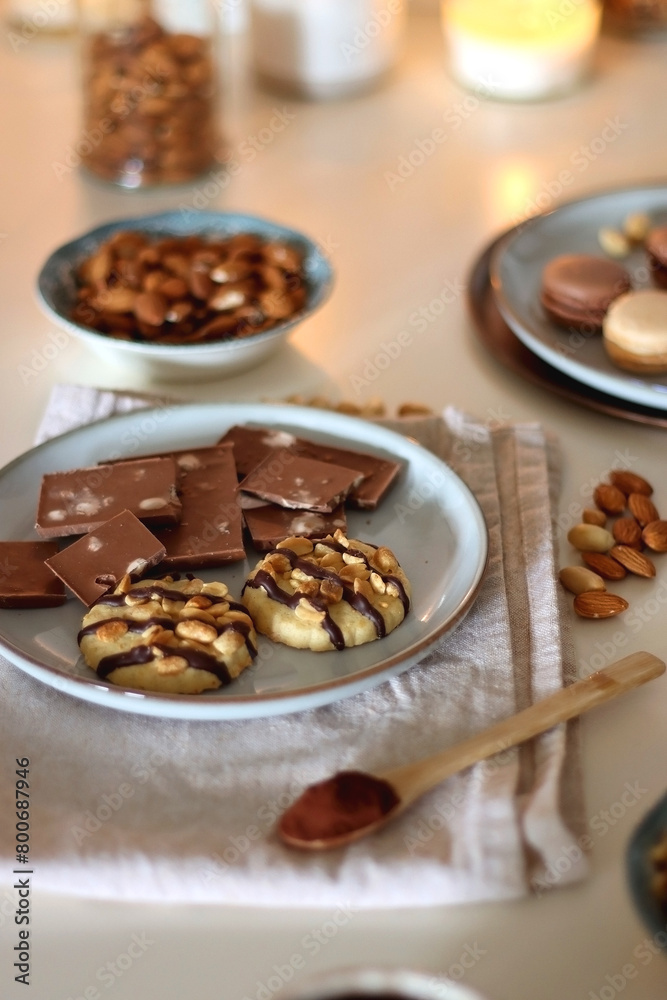 Cup of tea or coffee, cookies, macaroons, chocolate, various nuts and cocoa powder on white background. Selective focus. Cup of tea or coffee, cookies, macaroons, chocolate, various nuts and cocoa powder on white background. Selective focus.