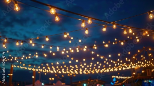 Decorative lights strung above the festival grounds illuminating the evening festivities.