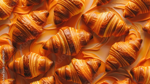 freshly baked croissants on swirling caramel background for bakery