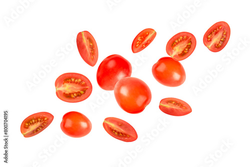 Falling tomatoes slices on white background.