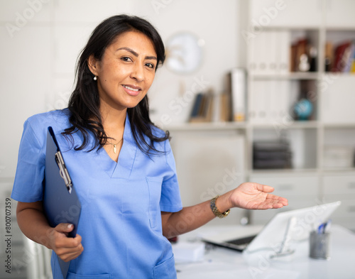 Woman-doctor in hospital office. Physician at work photo