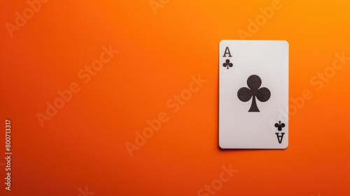 Ace of clubs playing card on orange background photo