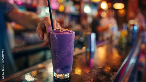 A bartender blending up a vibrant purple acai berry smoothie while patrons wait eagerly at the bar. photo