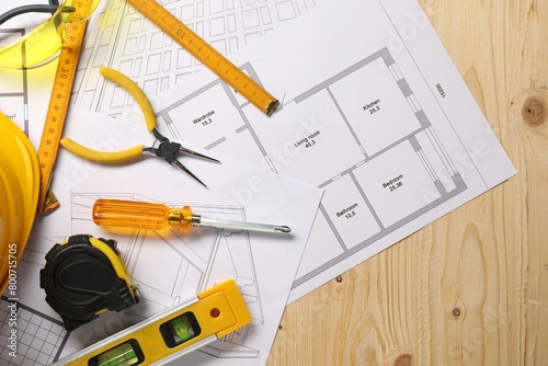 Flat lay composition with building level and other different construction tools on wooden background