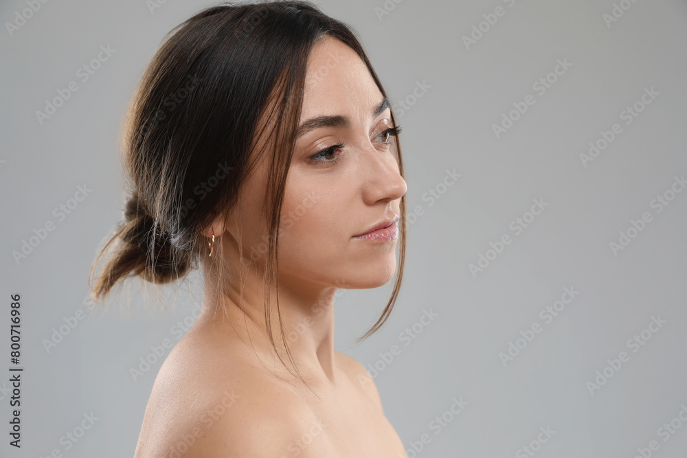 Portrait of beautiful woman on grey background Portrait of beautiful woman on grey background