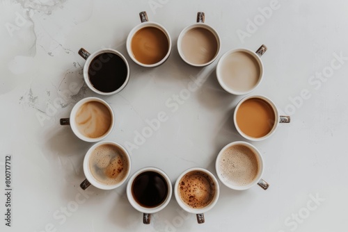 A top view of some coffee cups on a white background and they're in different types and colors. photo