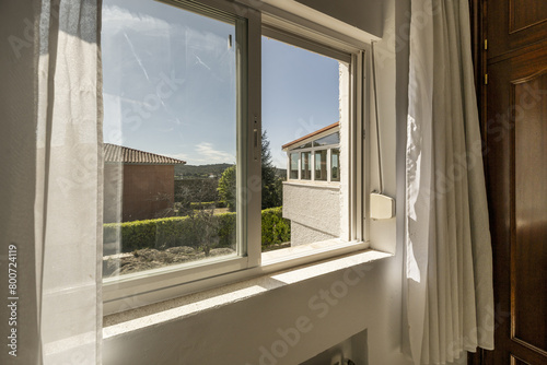 Bedroom window with wardrobe with sapelly doors and mountain views