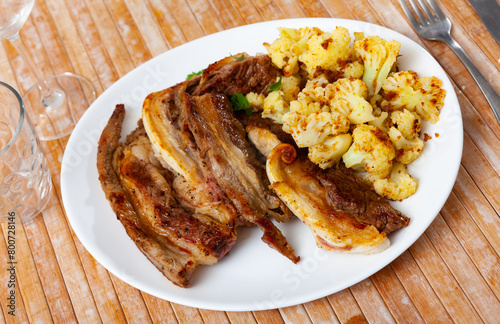 Delicious roasted lamb with cauliflower served on platter
