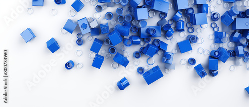 Scattered Blue Lego Building Blocks on White Backdrop © heroimage.io
