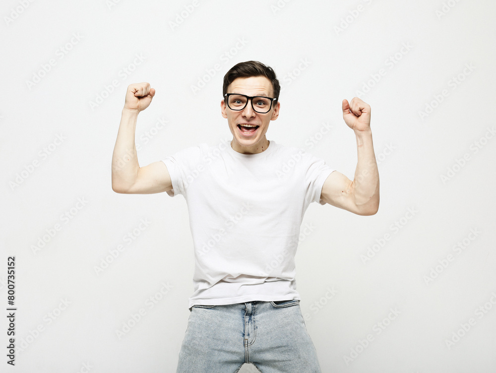 Fototapeta premium young man celebrating victory over white background
