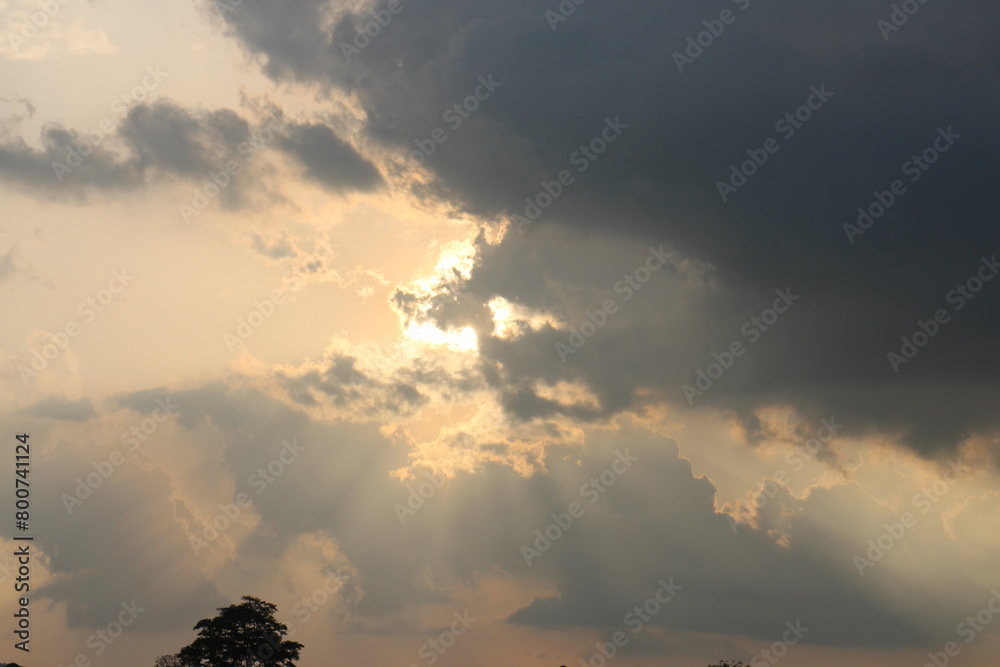 Naklejka premium Sky blue and orange light of the sun through the clouds in the sky
