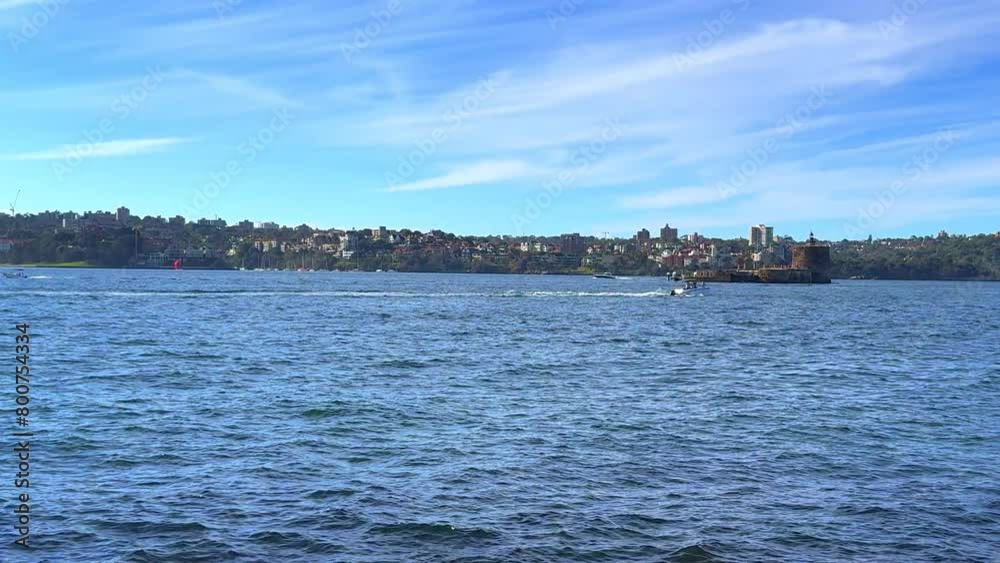Sydney Harbour forshore viewed from the Gardens in NSW Australia on a nice sunny and partly cloudy afternoon blue skies Sydney Harbour forshore viewed from the Gardens in NSW Australia on a nice sunny and partly cloudy afternoon blue skies