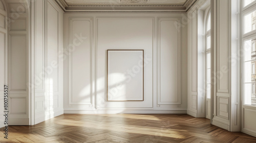 A large empty room with a white wall and a large picture frame. The room is very spacious and has a lot of natural light coming in through the windows