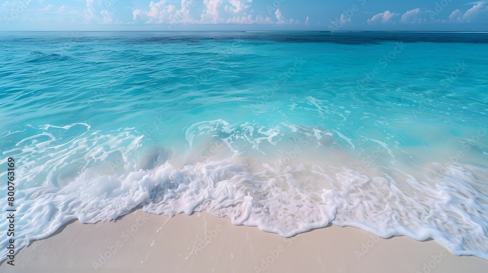 A tranquil paradise features a beautiful beach with sunlit skies and crystal clear blue waters. The white sand complements the shining sun, which creates a sparkling dance of light on the turquoise