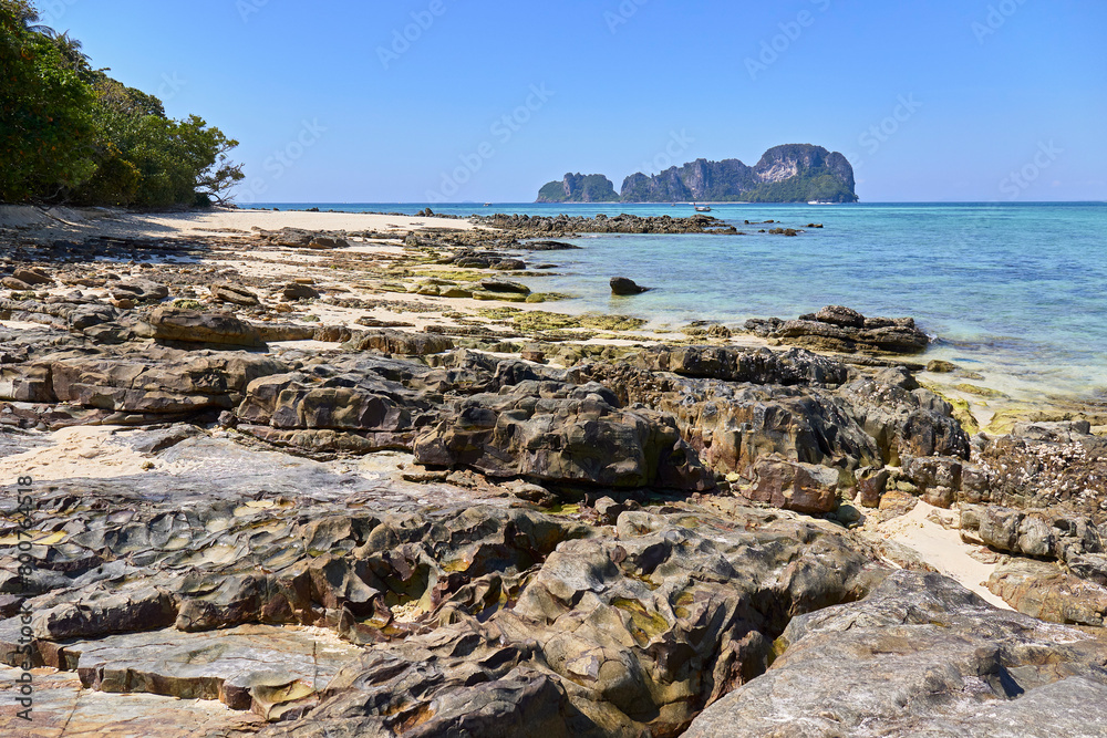 Rocky coast on the background of karst mountains, sea and boats