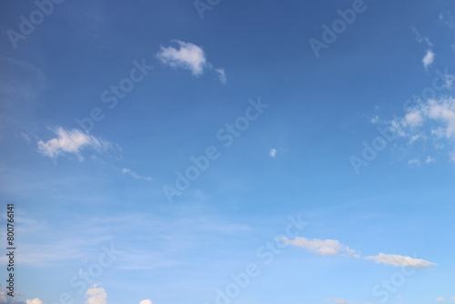 blue sky background with tiny clouds photo