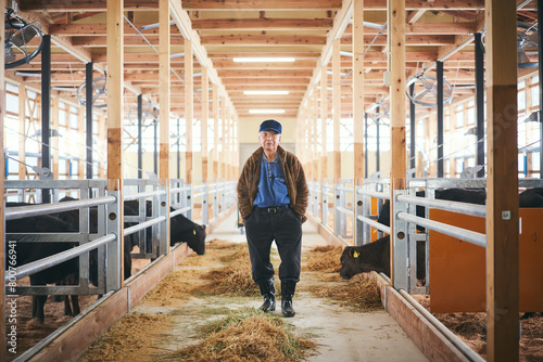 牛舎に立つシニア男性 photo
