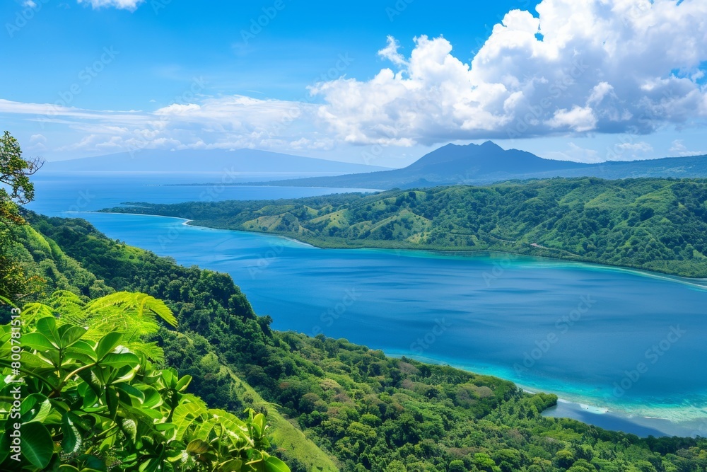 A panoramic view of a long, pristine beach stretching towards the horizon, flanked by lush green hills and crystal-clear turquoise water