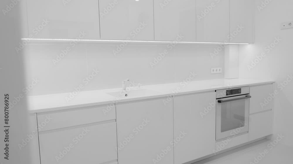 Modern trendy snow white kitchen interior with acrylic countertop and built in acryl sink, luxury monochrome design, Nobody Modern trendy snow white kitchen interior with acrylic countertop and built in acryl sink, luxury monochrome design, Nobody